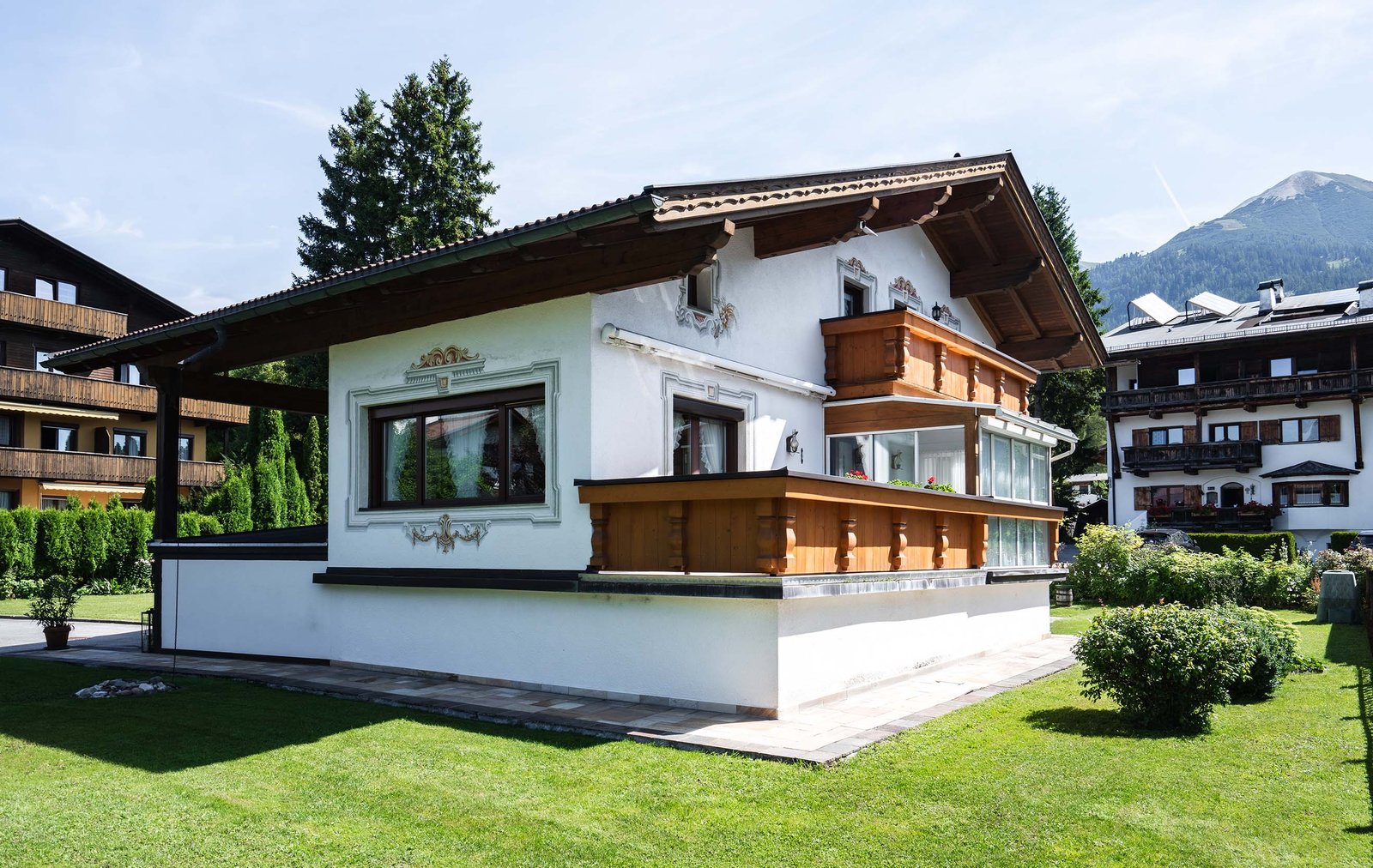 Rückseite von Haus Erika mit Holzbalkon und Wintergarten